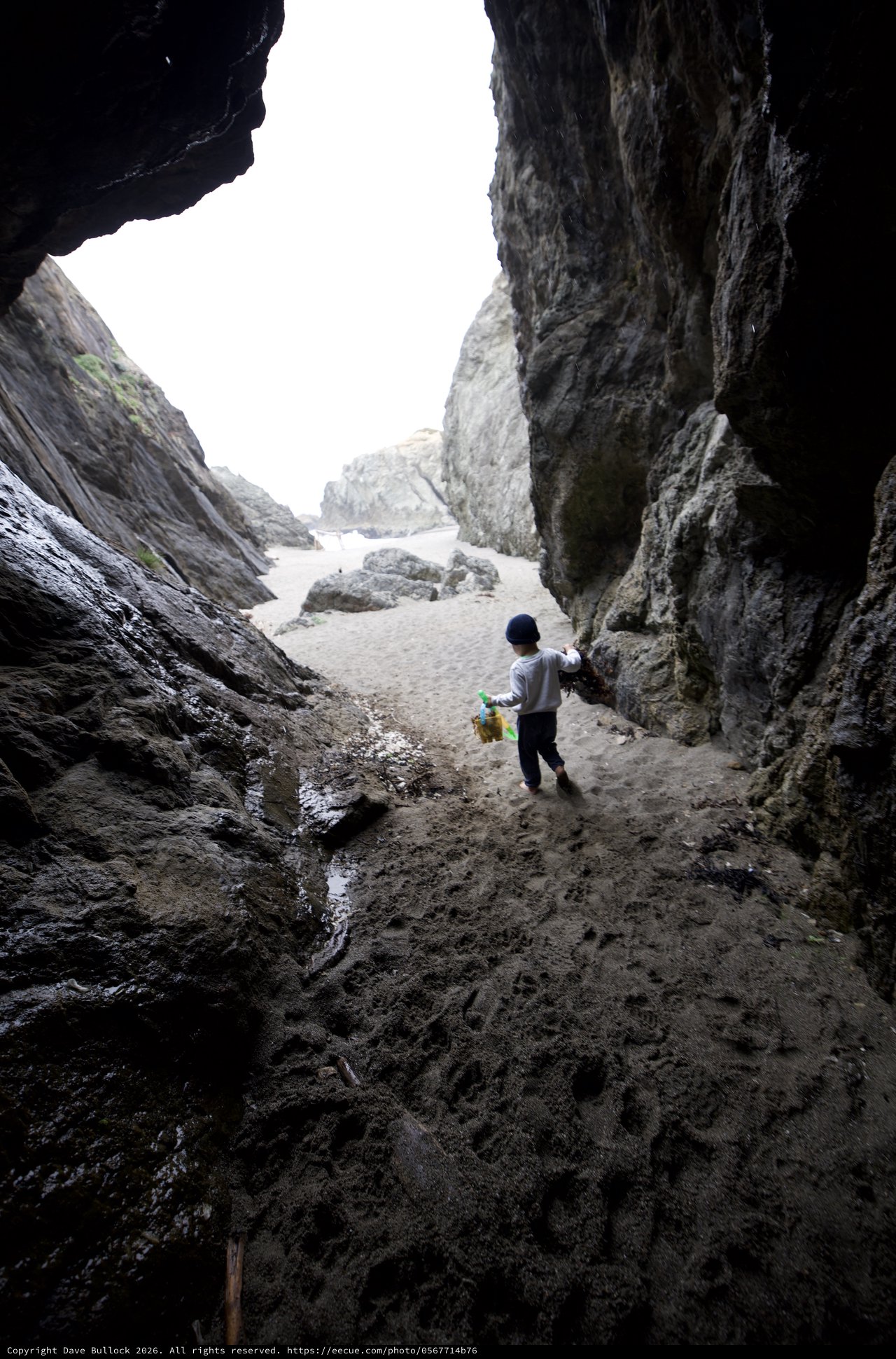 Child Explorer Ventures Through Coastal Sea Cave