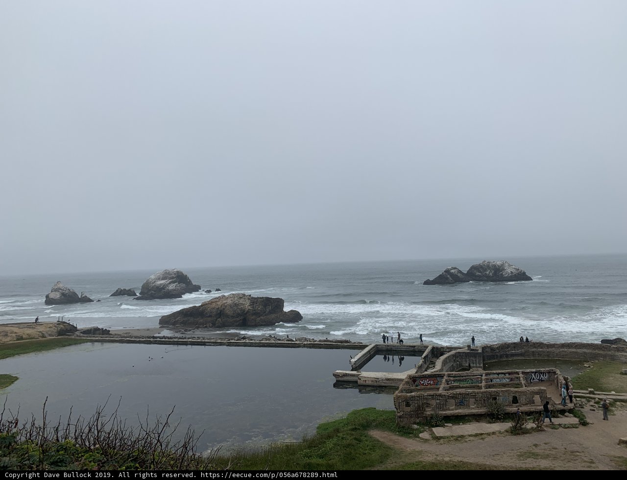 Promontory Views Caption: A stunning view of the ocean from the grassy hill overlooking the coastline of Lands End, San Francisco, California.