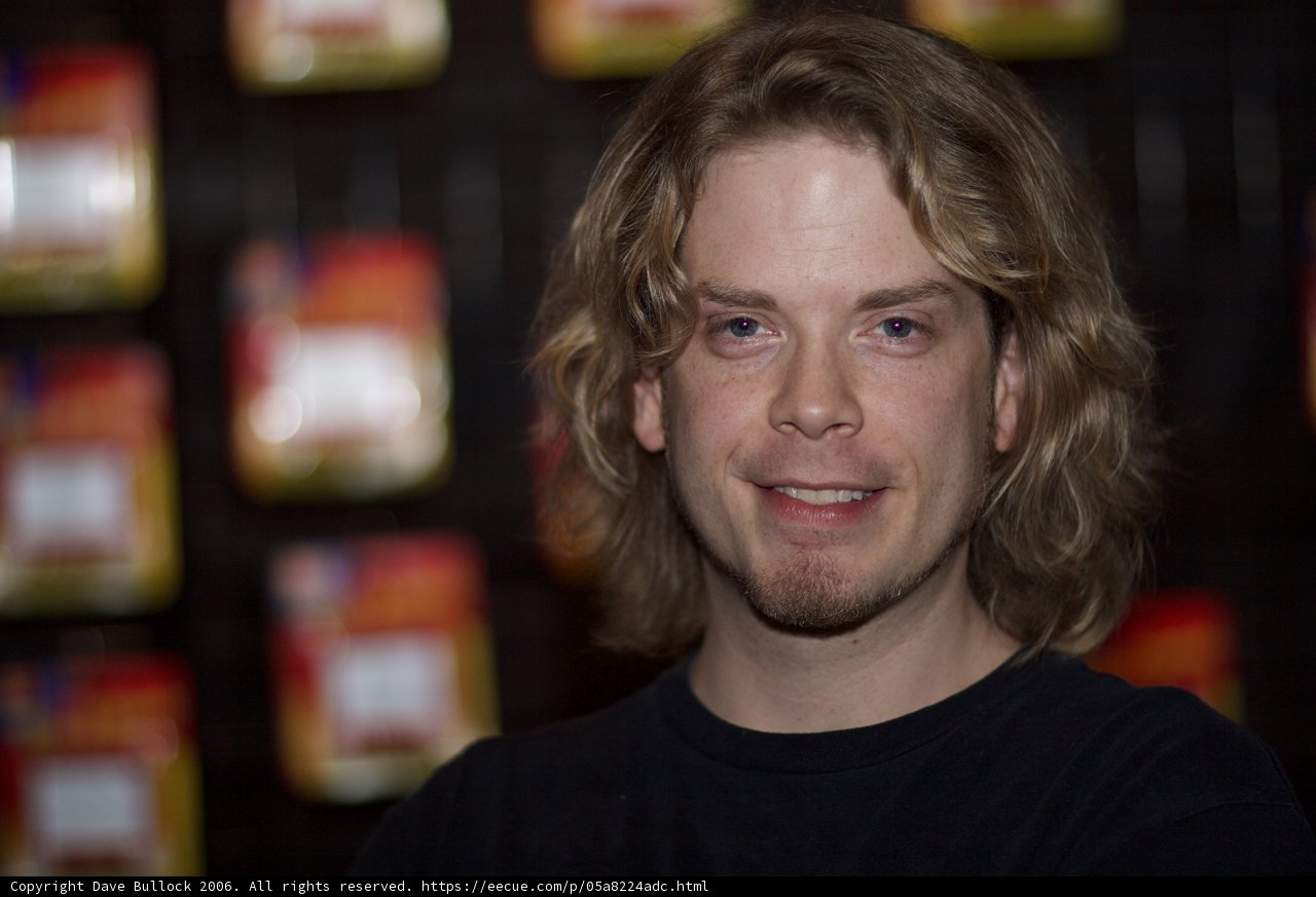 Happy Man with Long Hair in Pantry