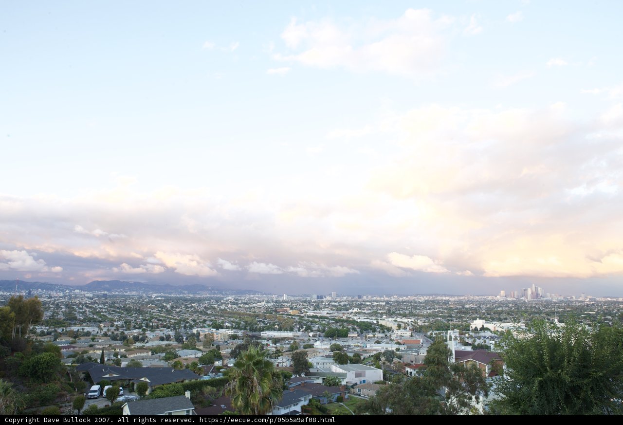 View of Cityscape from Hilltop with Flying Plane