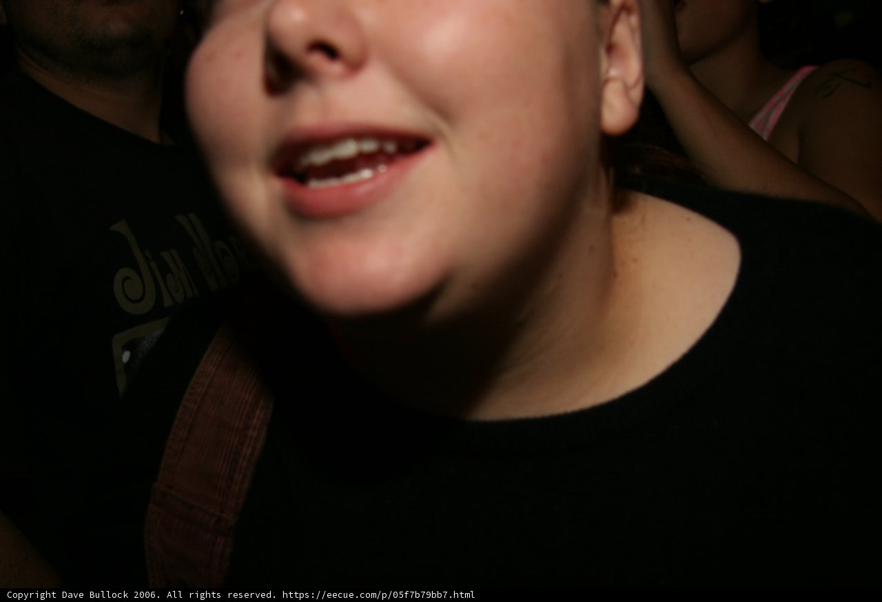 Black Shirted Woman with Background Man
