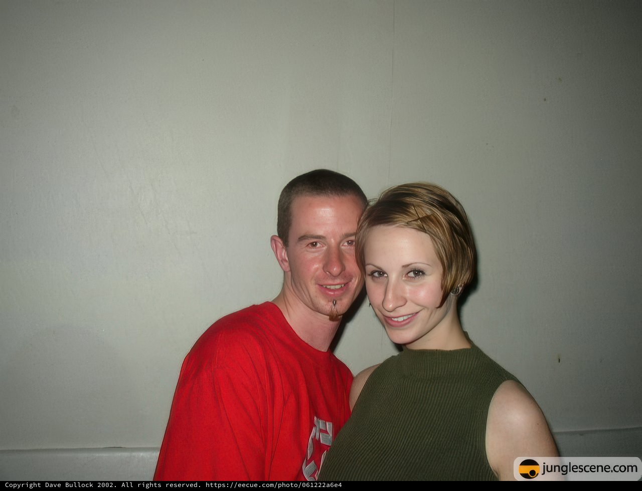 Smiling Couple in Front of Wall
