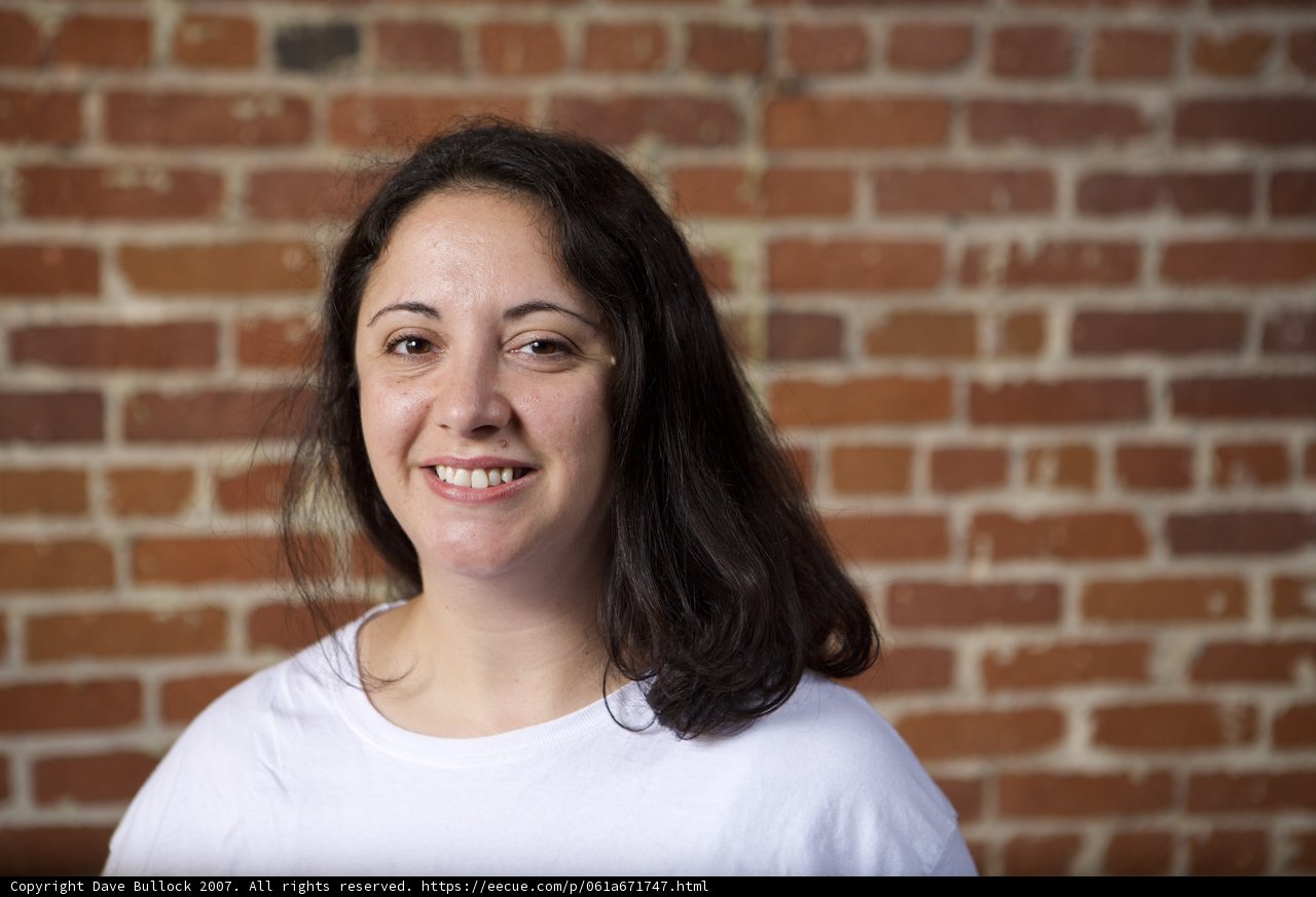 White Smile Against Brick Wall
