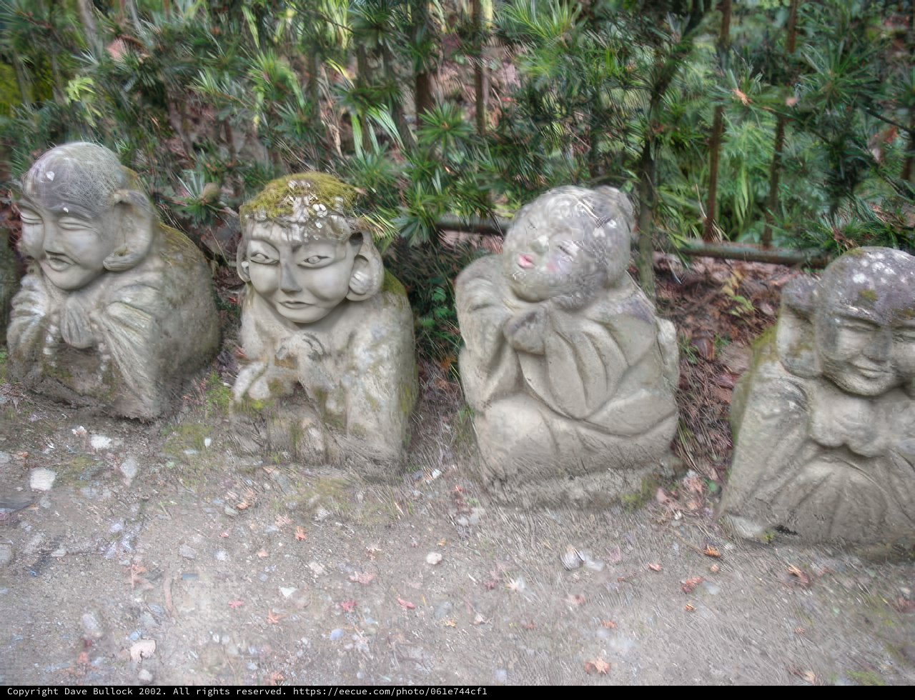 Smiling Stone Statues at Monastery Garden