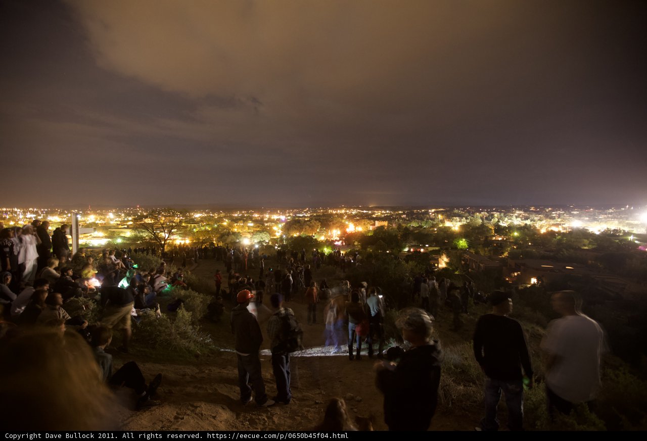 Nighttime Vigil with Urban Skyline View