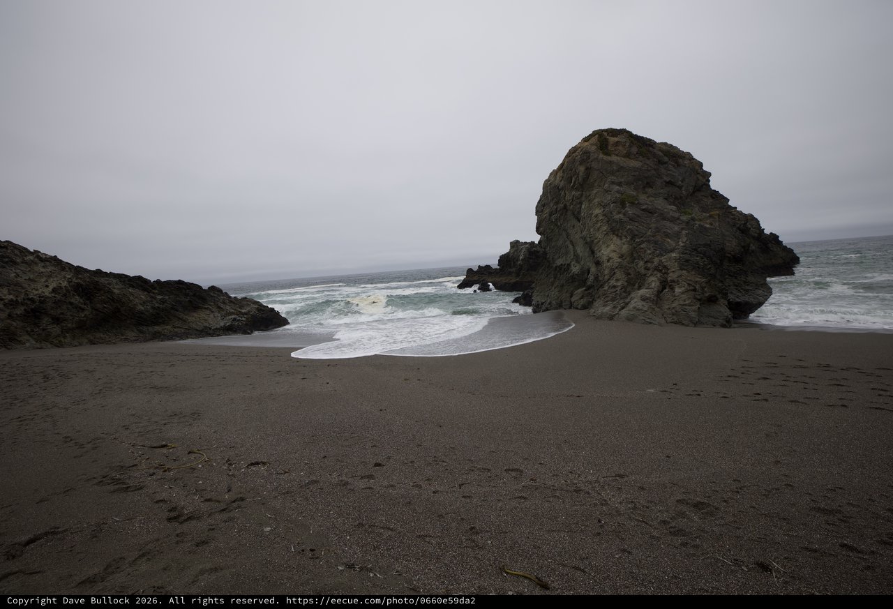 Moody Coastal Rock Formation on Foggy California Beach