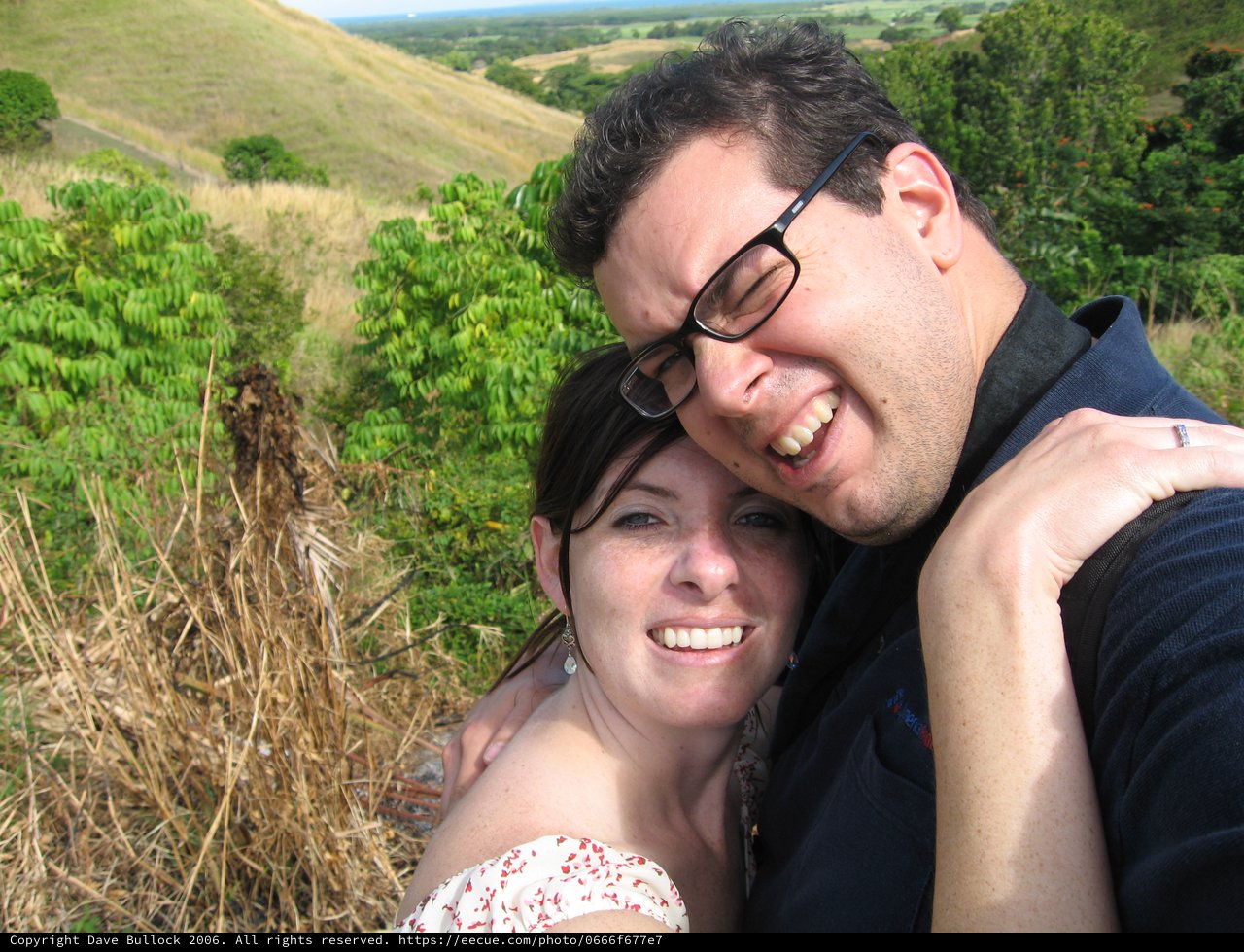 Joyful Couple Embracing on a Scenic Hillside