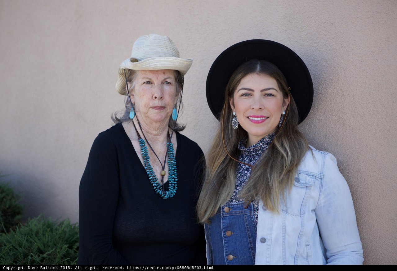 Two Women in Hats and Overalls