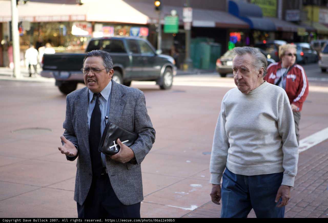 Two Businessmen Strolling Down the City Street