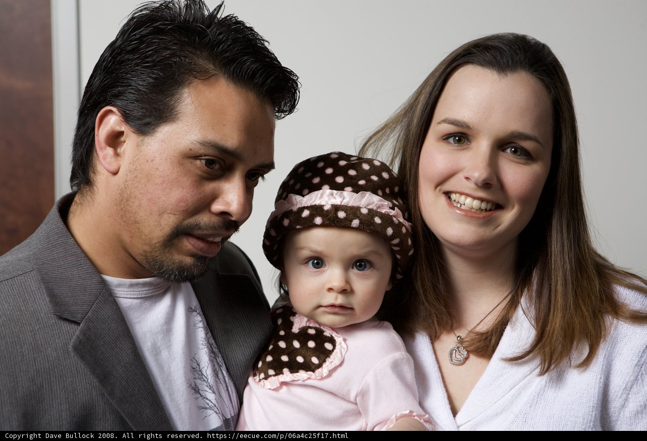 Smiling Family with a Newborn Baby
