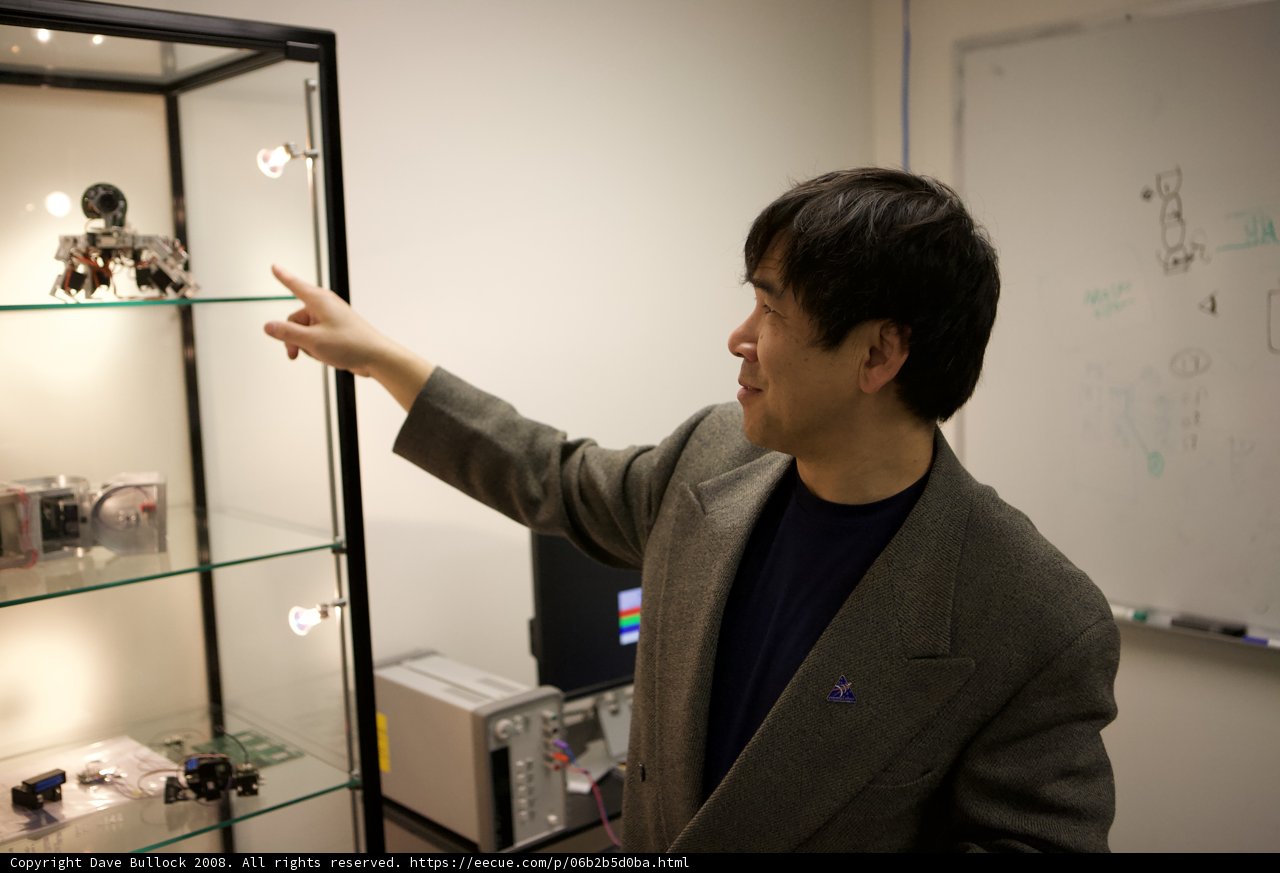 Man Examining Display Case in USC Office