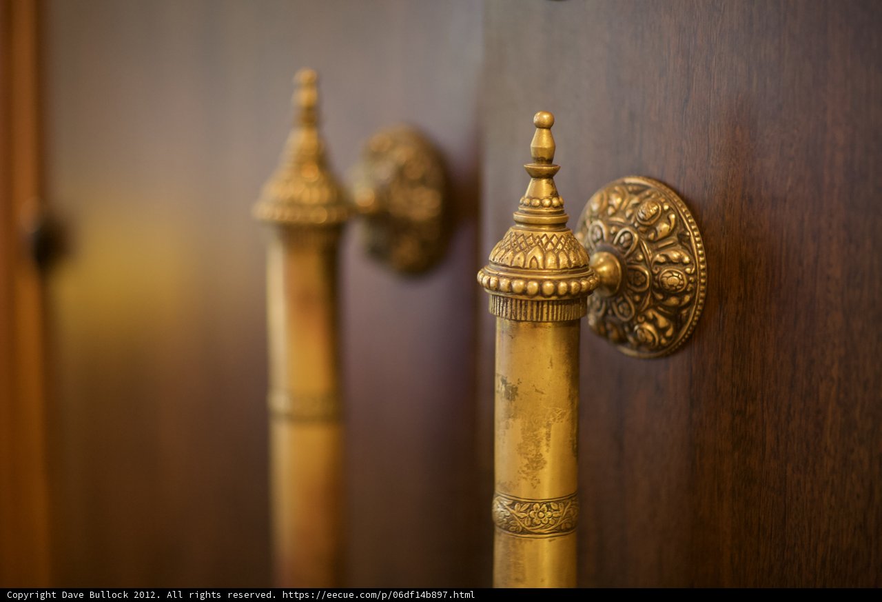 Brass Knobs on a Wooden Door