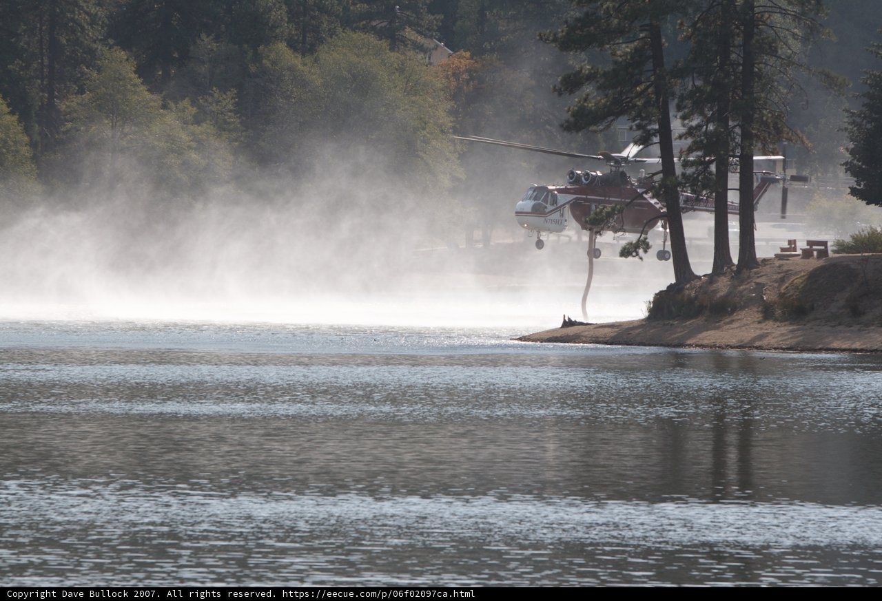 Helicopter Spraying Water on Lake