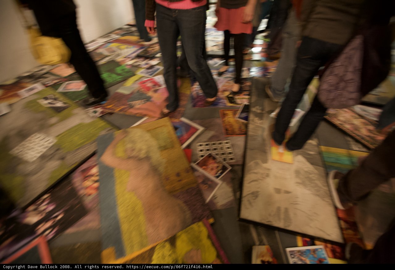 A Group Admiring Art Pieces on a Colorful Floor