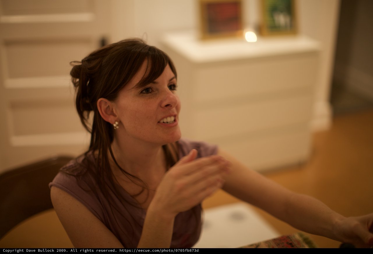Penelope Engaged in Animated Conversation at Gallery