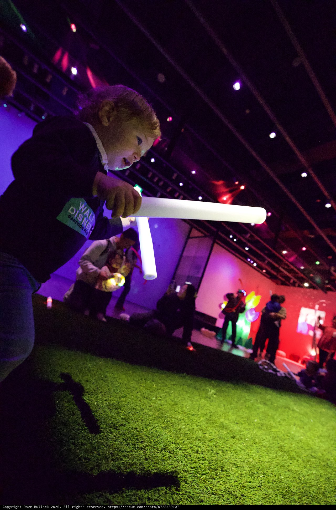 Child Playing with Light Tube at Baby Rave Event