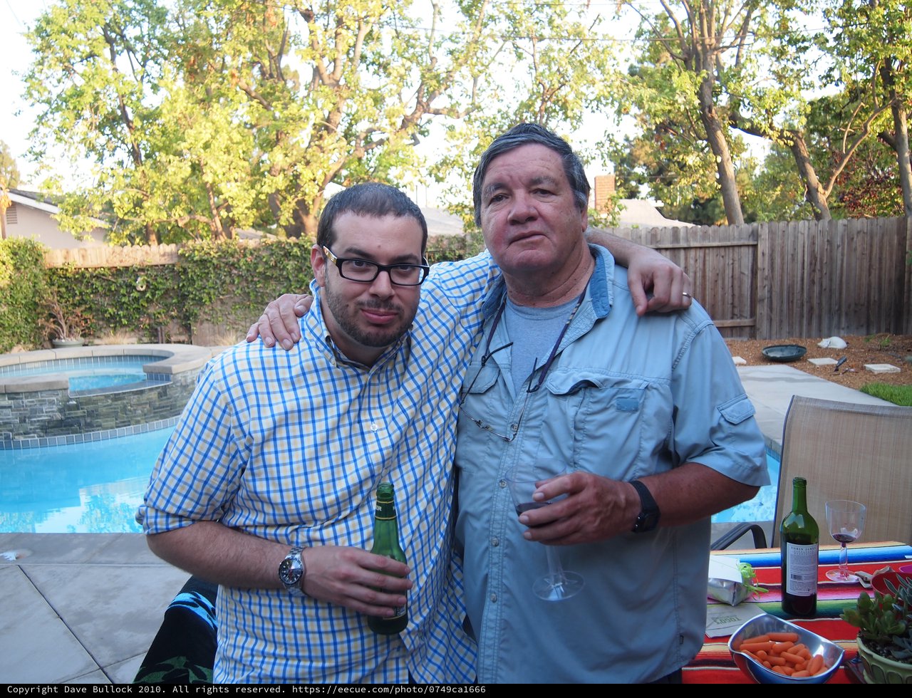 Two Friends Celebrating at a Backyard Pool Party