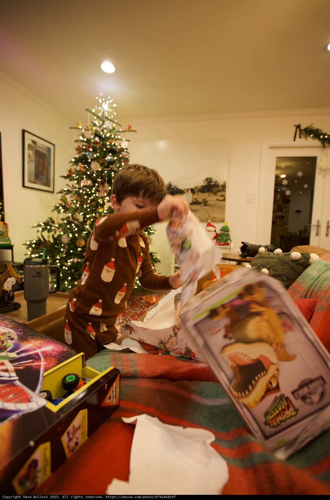 Child Opening Christmas Presents on Christmas Morning