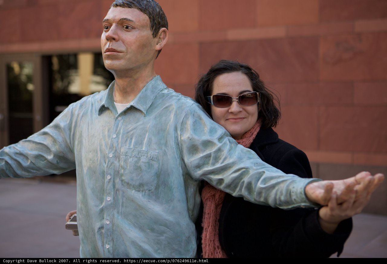 A Couple Admiring The Statue