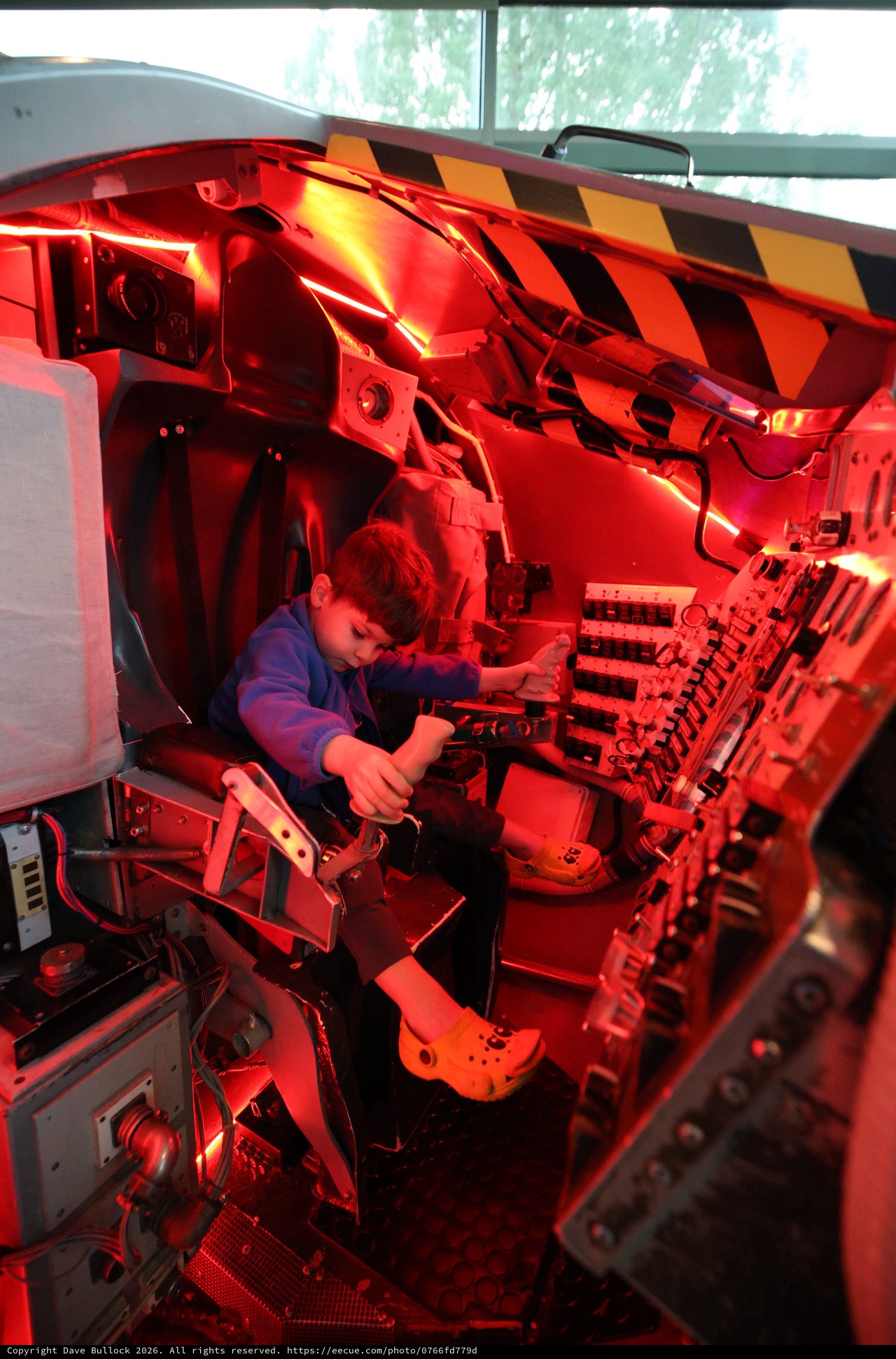 Young Visitor Explores Space Shuttle Cockpit Simulator