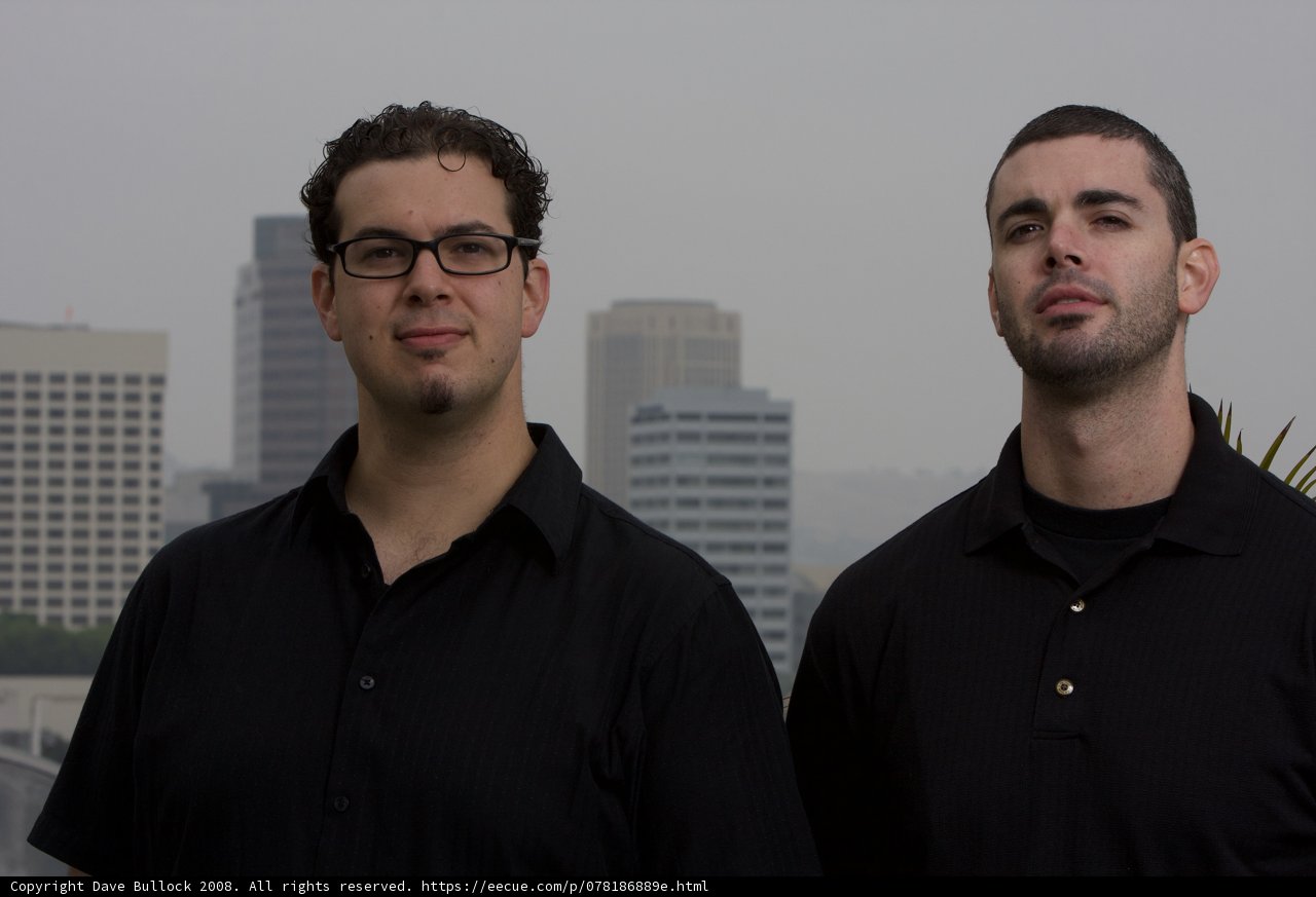 Two Happy Men in Black Shirts in the City