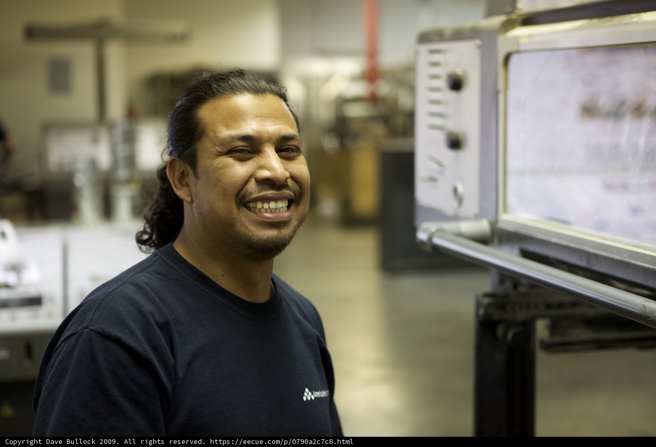 Man with a Smile in Front of Electronic Monitor