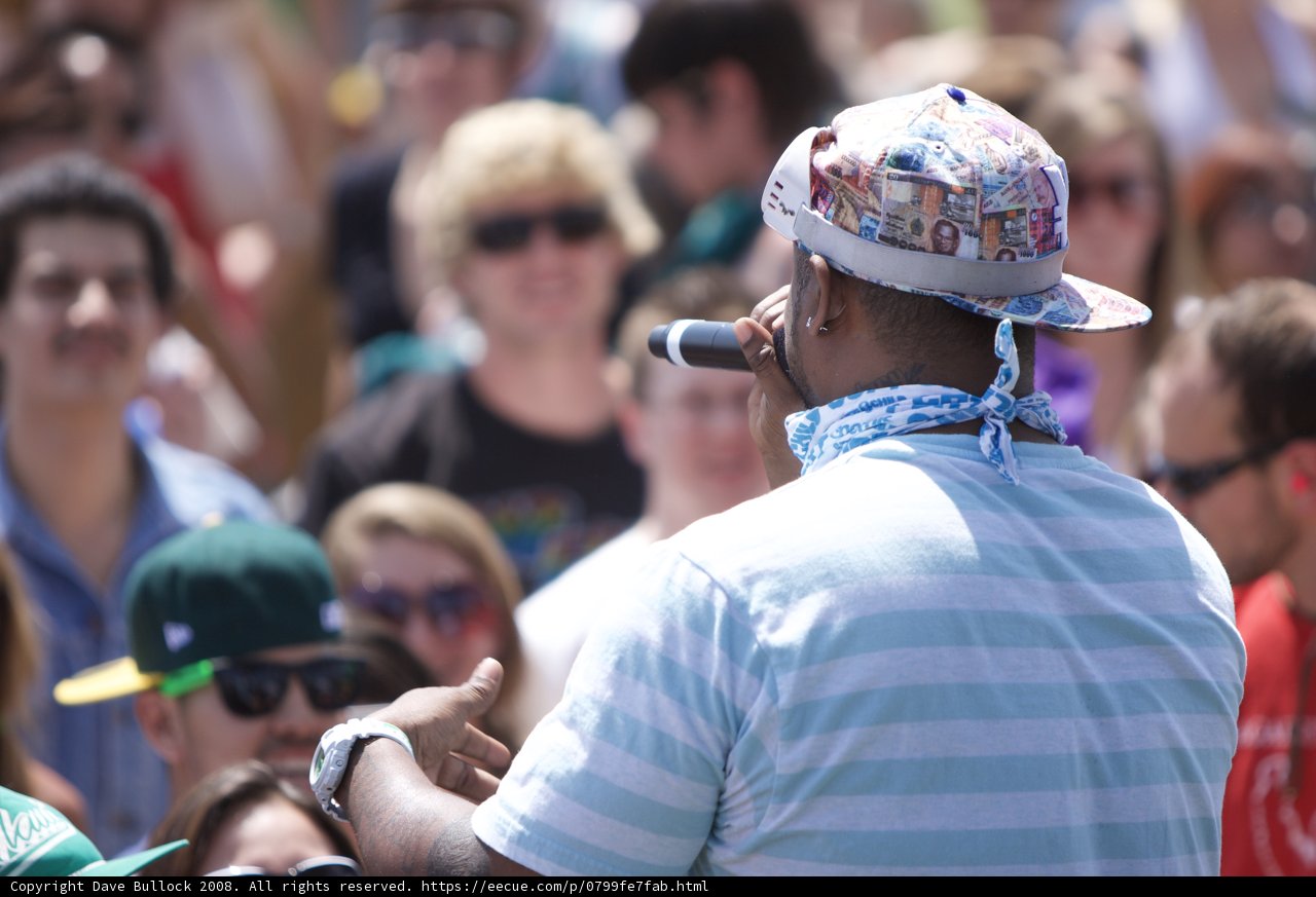 Man in Blue Shirt and Hat Performing at Coachella Music Festival