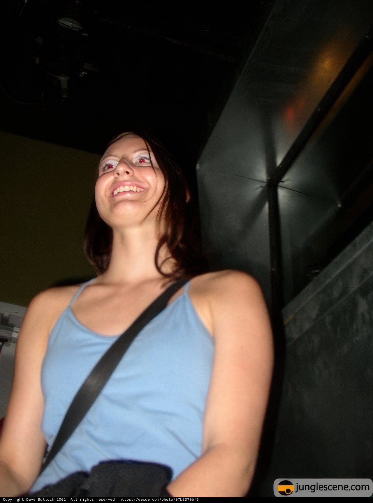 Smiling woman captivated by her cell phone