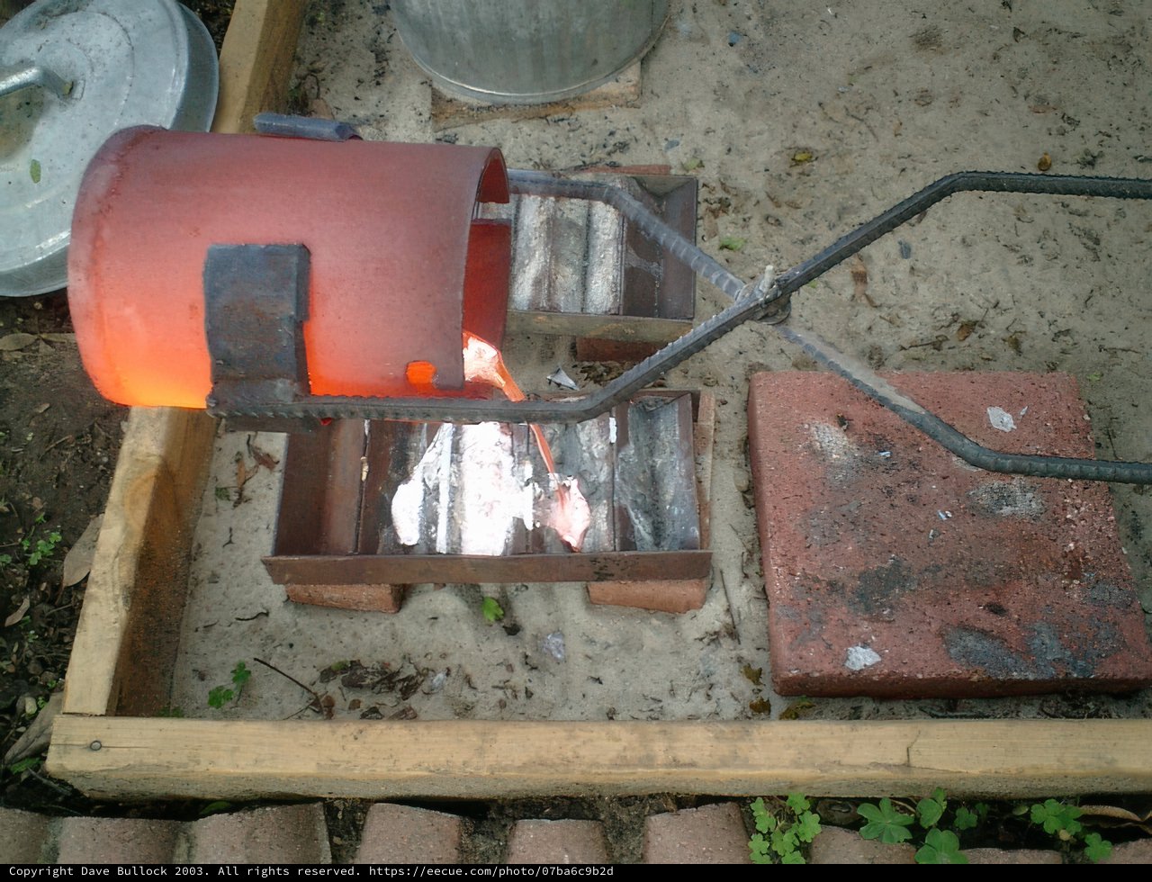 A Red Pot on a Metal Grate