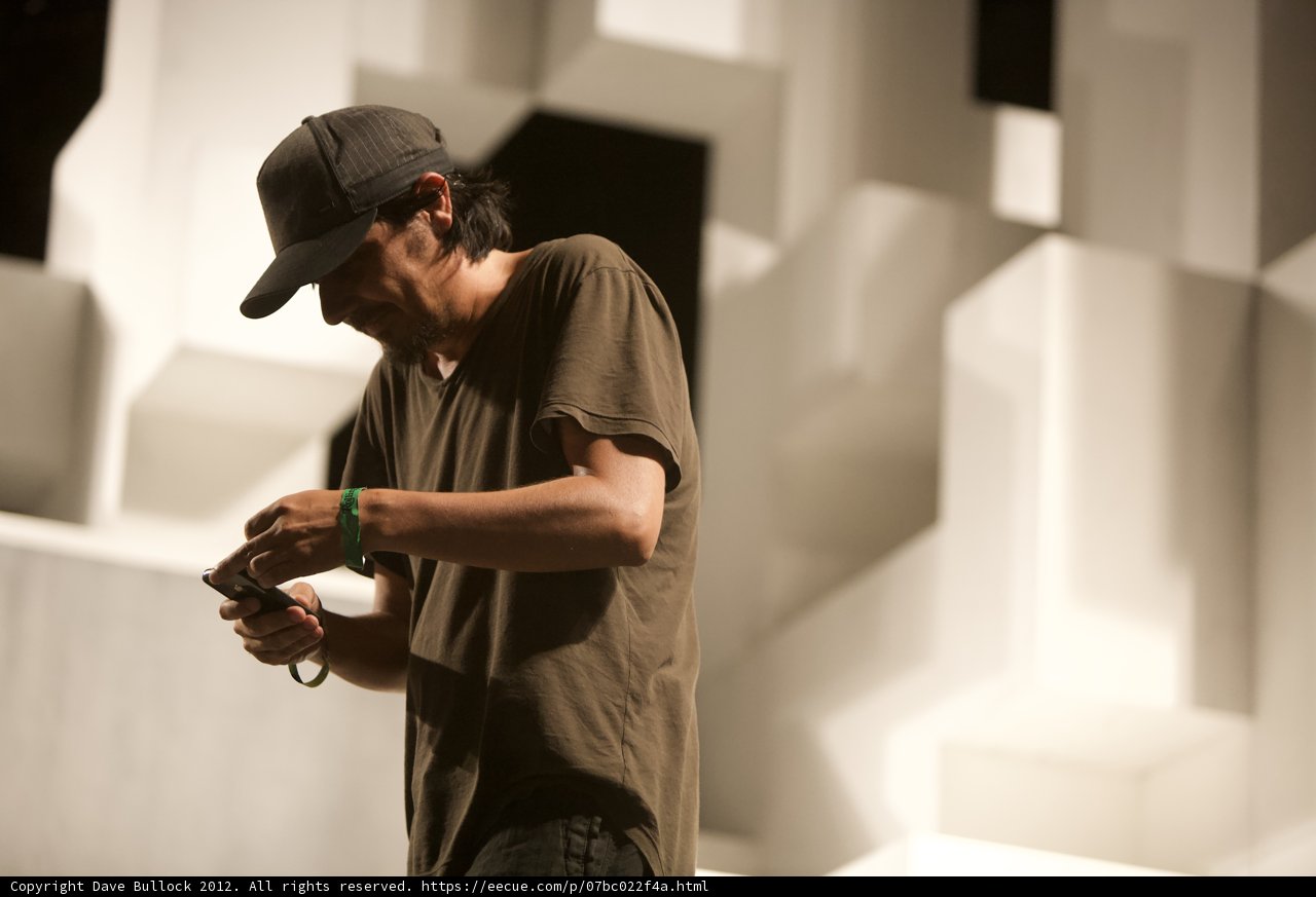 Man in Baseball Cap Checking Phone at Coachella