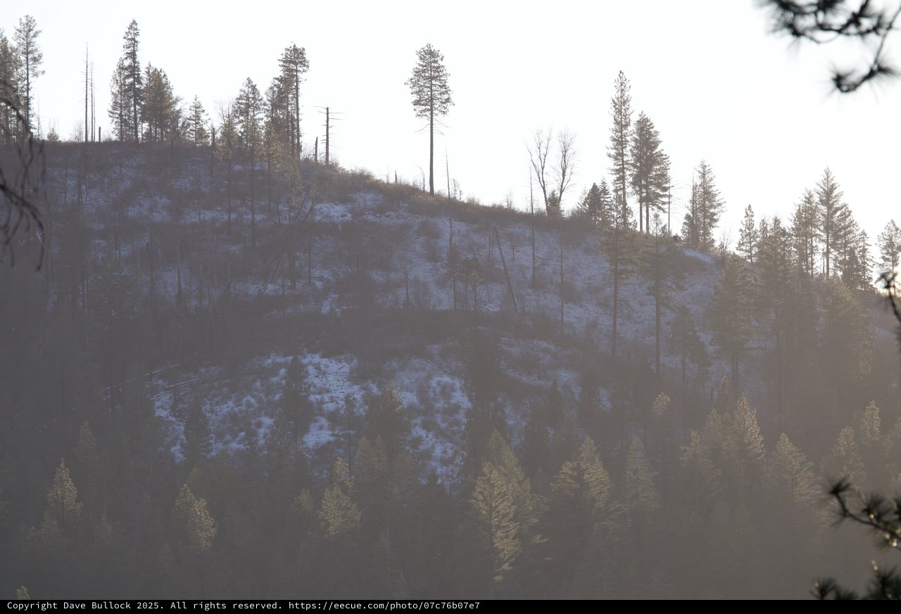 Winter Hillside with Power Lines and Sparse Snow