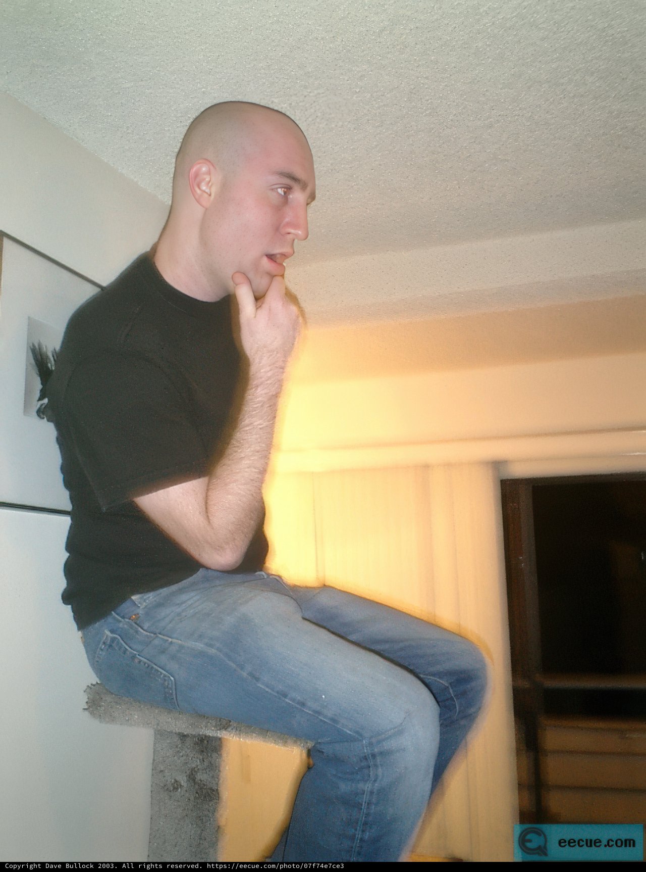 Bald Man Lounging in Comfortable Jeans