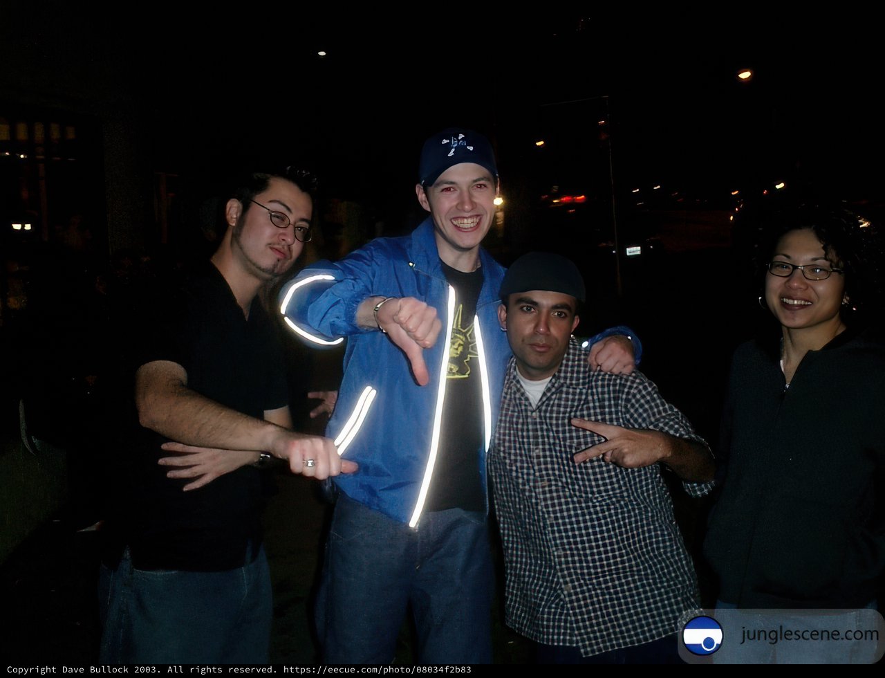 Four Men in Baseball Caps Under the Night Sky