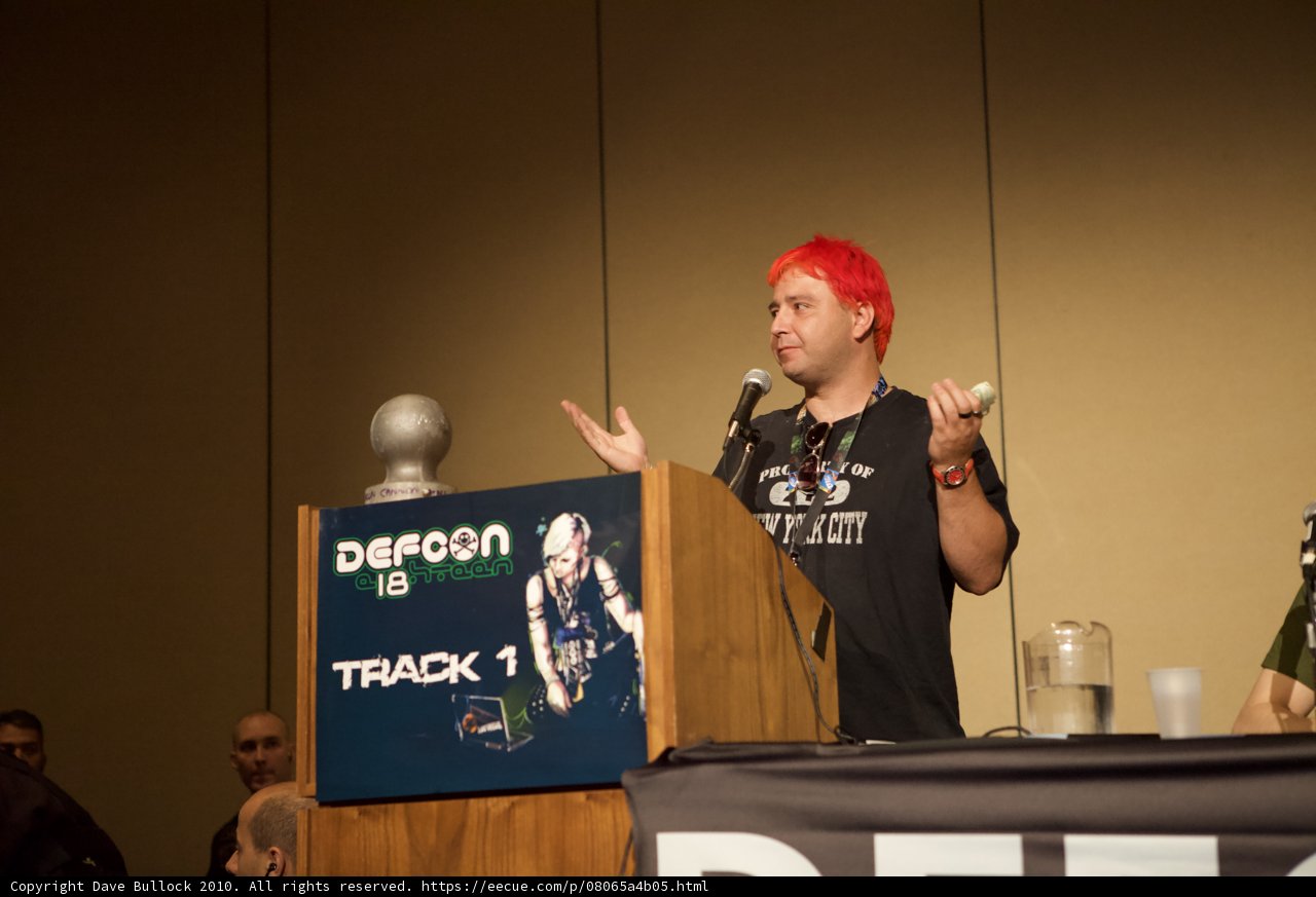 Red-haired speaker addresses crowd at DefCon 18