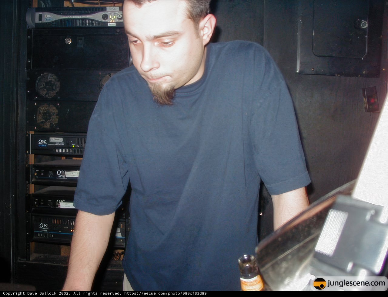 Blue-Shirted Man with Electronics