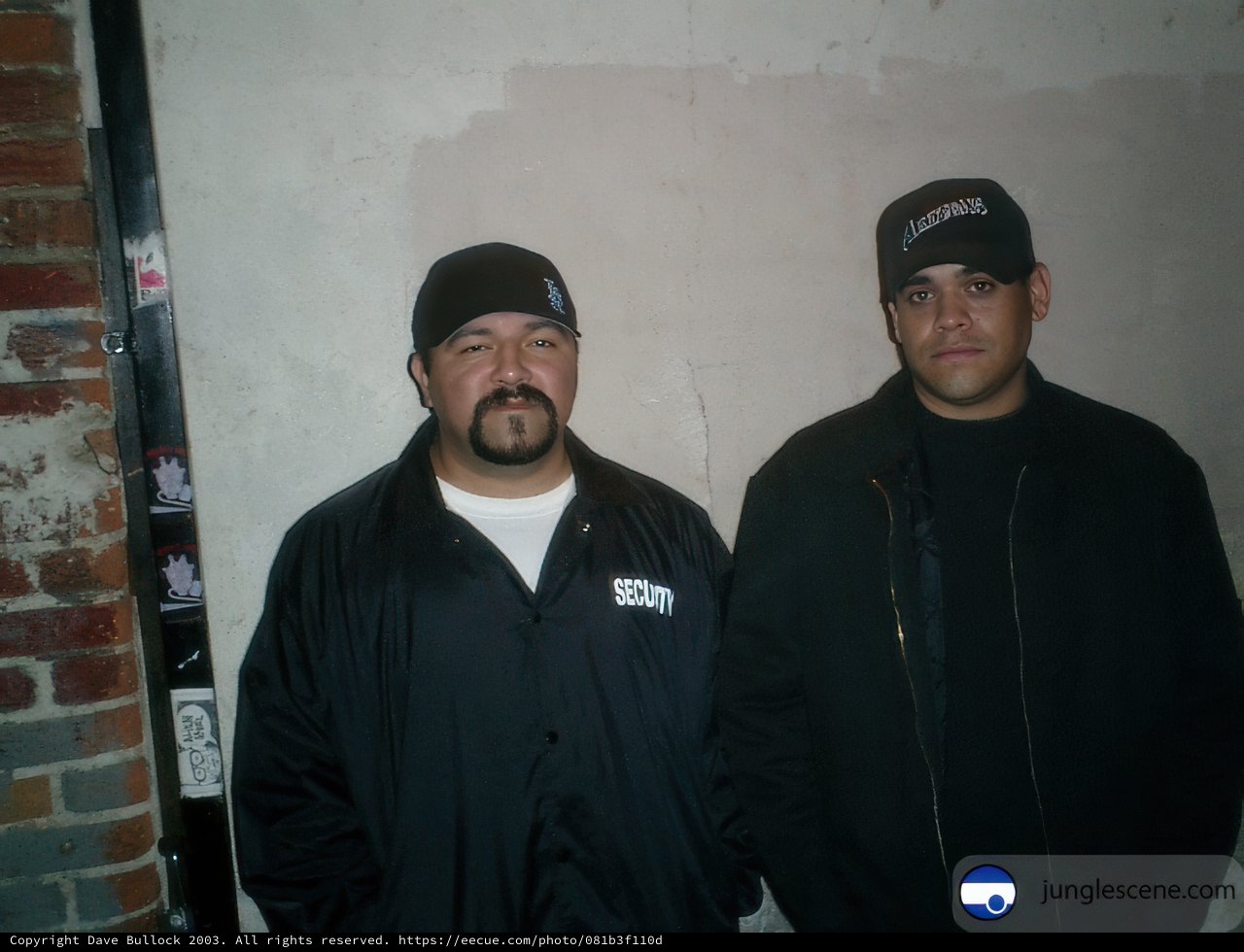Two Men Posing in Headgear and Jackets