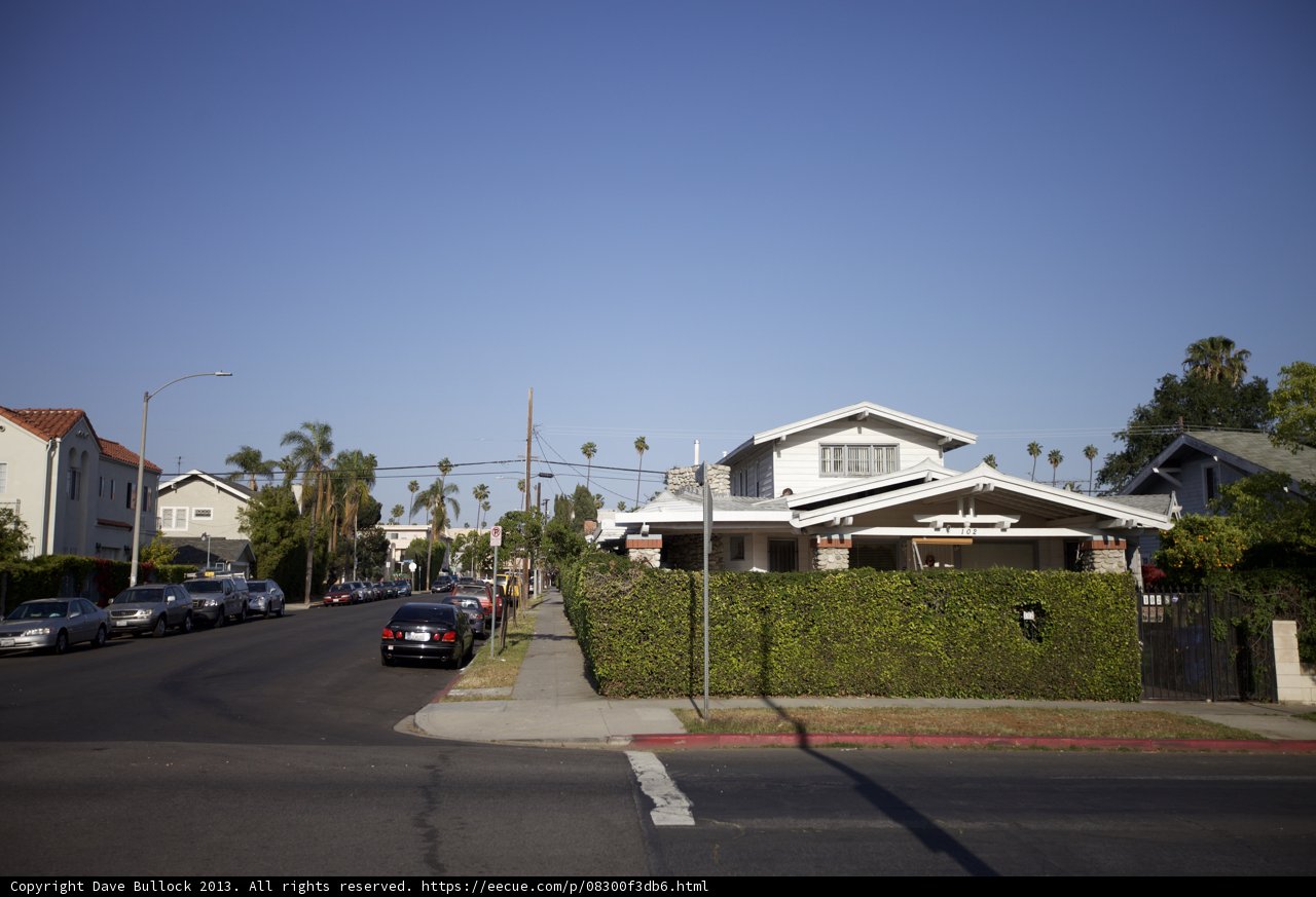 Neighborhood Street with Parked Cars and House