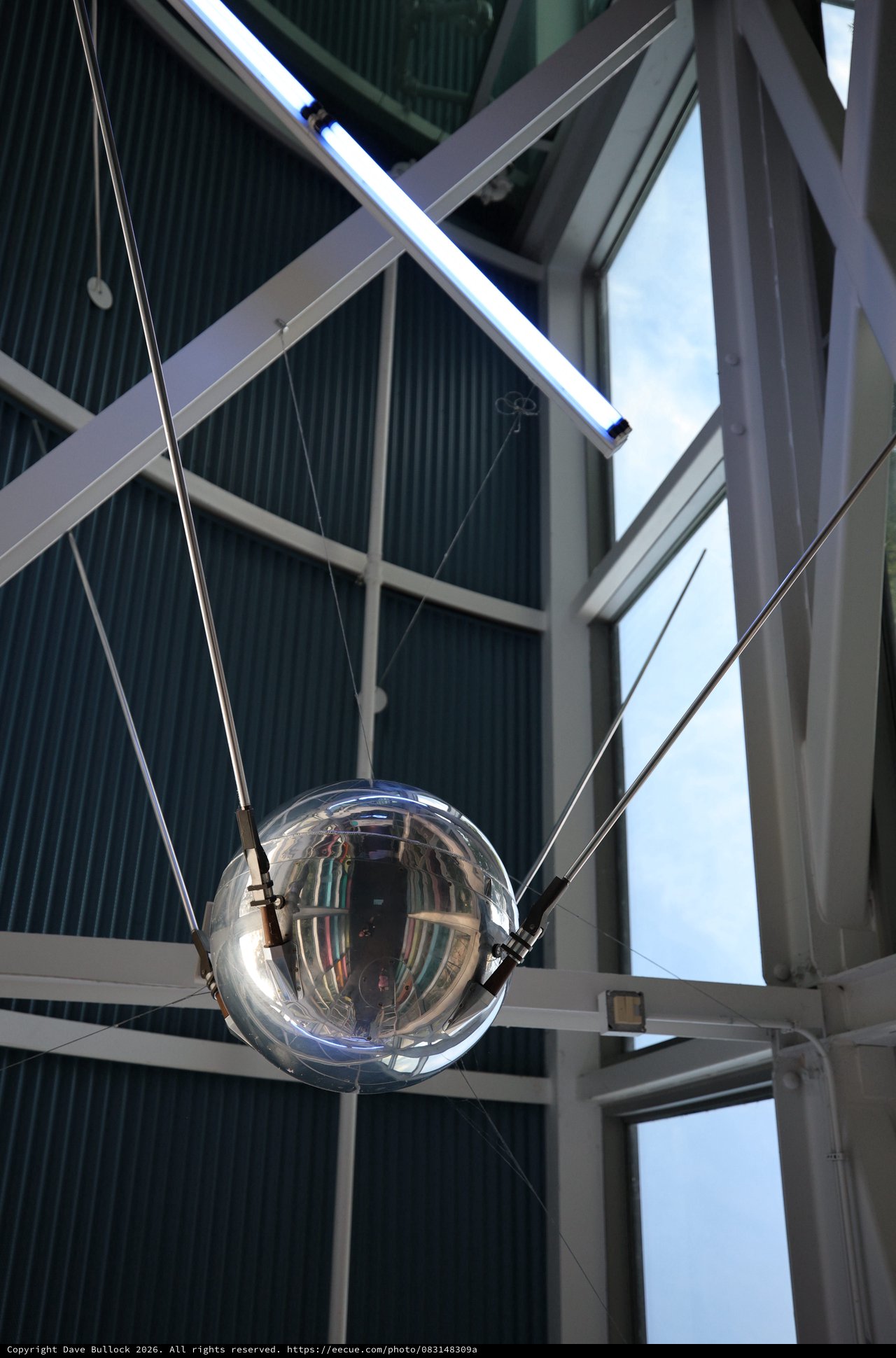 Reflective Satellite Sphere Suspended in Modern Atrium