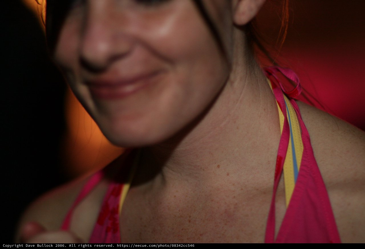 Smiling Woman in Pink Bikini at Warm Gathering