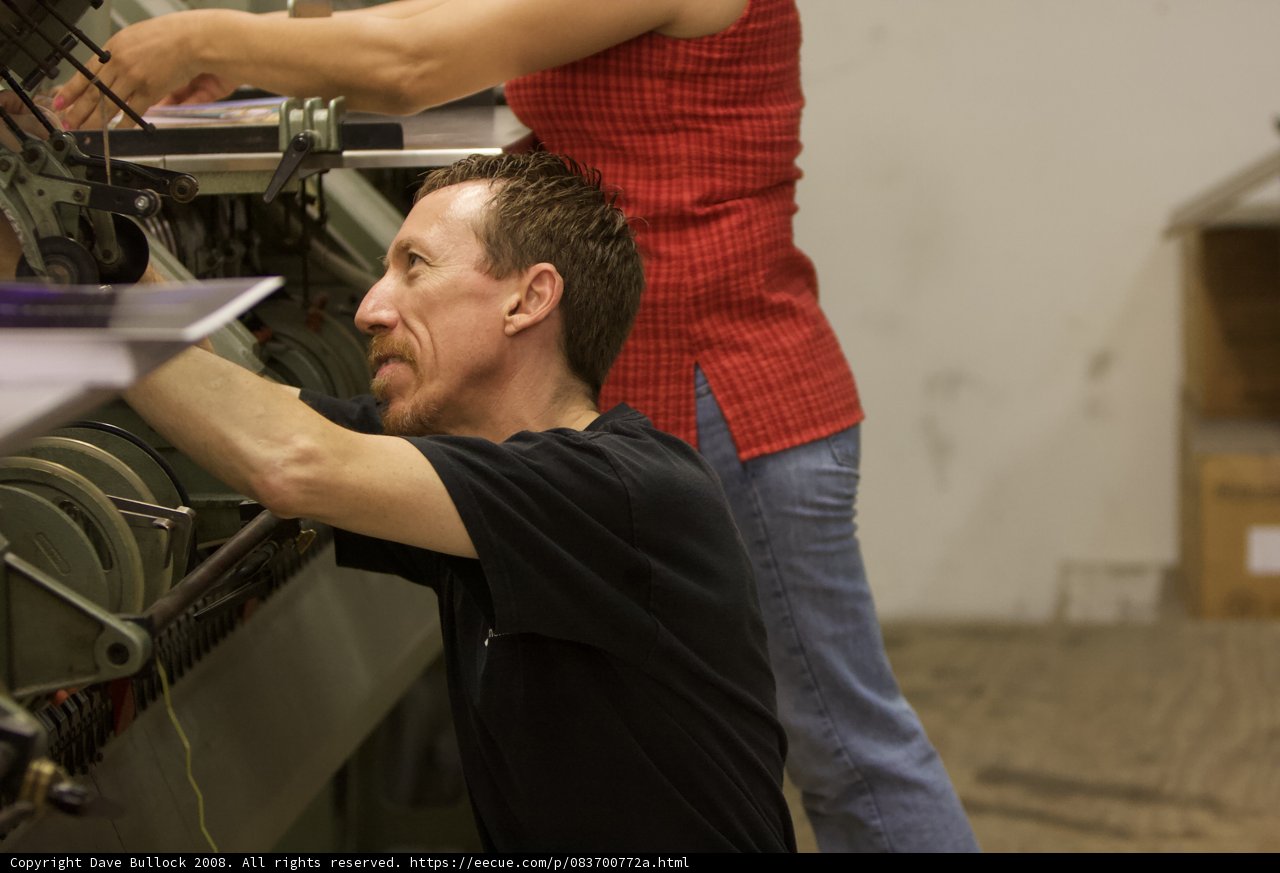 Red Shirted Men in a Manufacturing Workshop