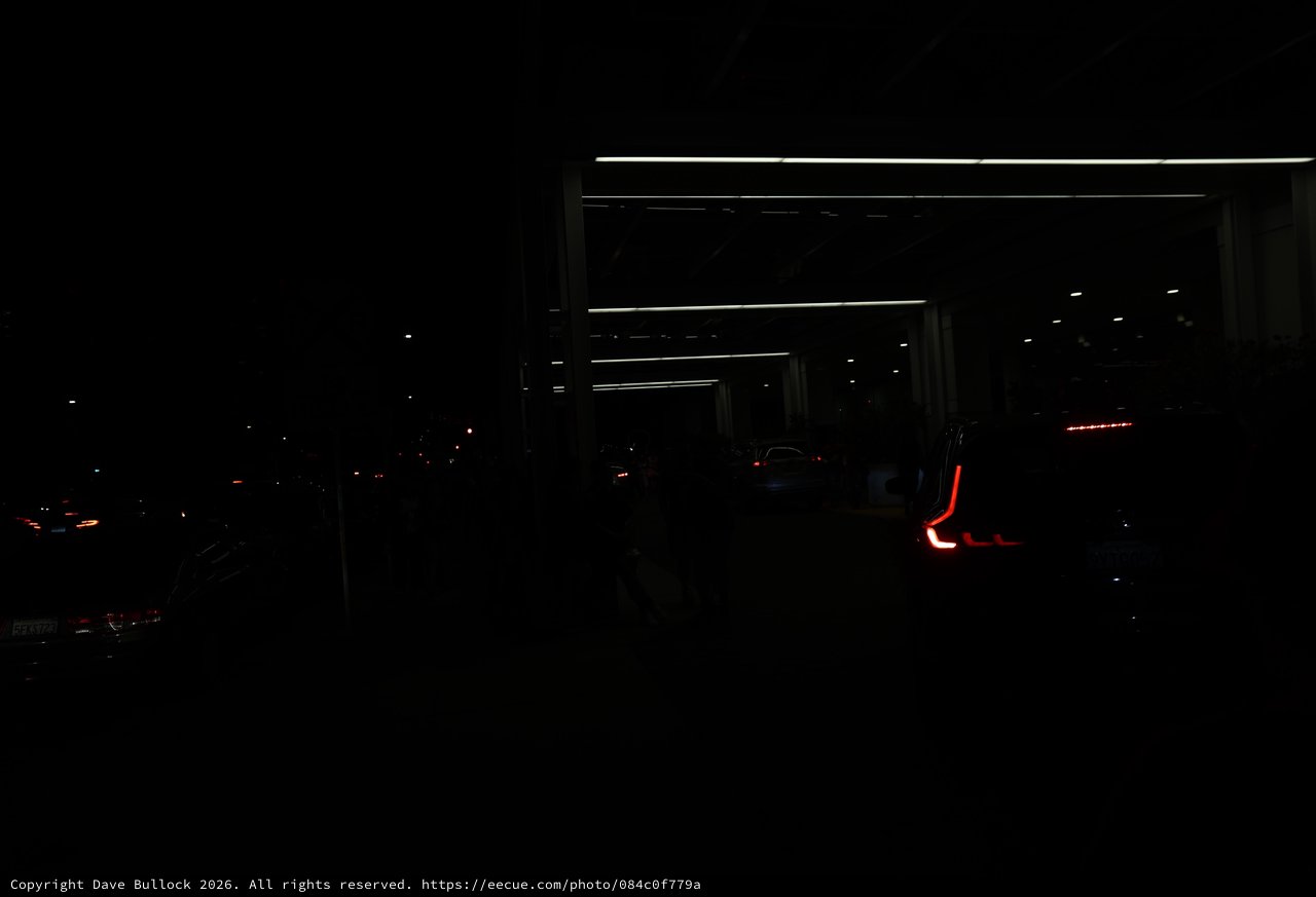 Red Taillights Glow in Dark Parking Structure Night