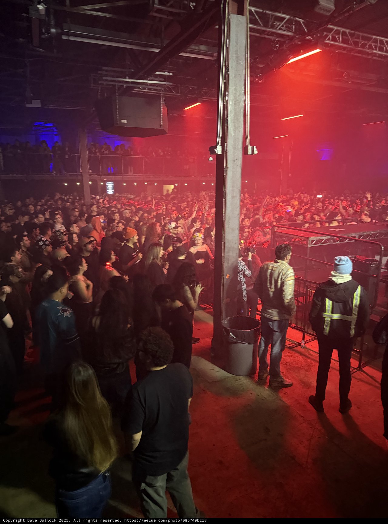 Red-Lit Concert Crowd from Side Stage View