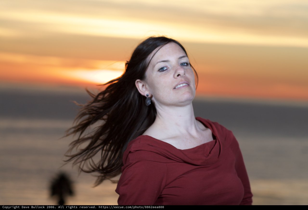 Wind-Swept Woman at Golden Sunset by the Sea