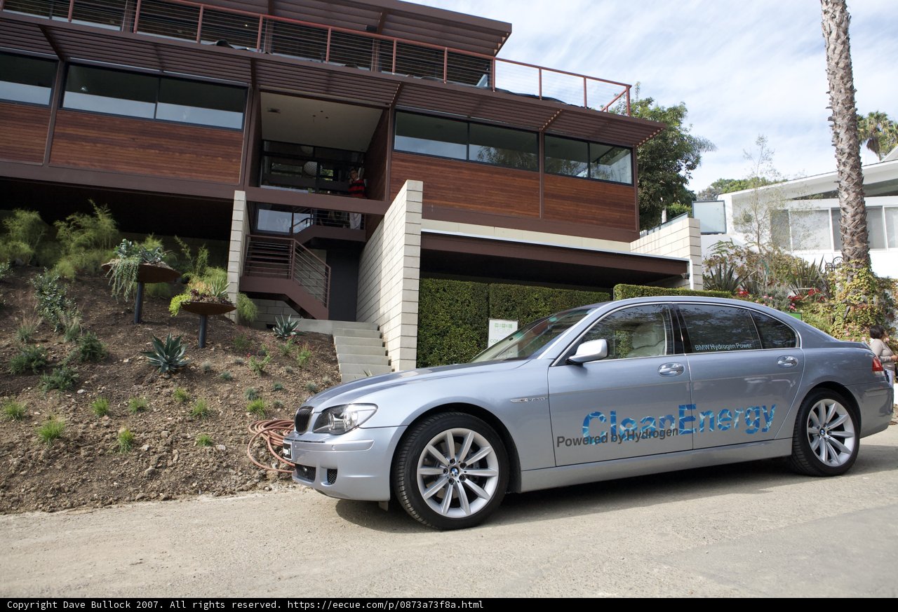 Silver BMW parked in front of a living home