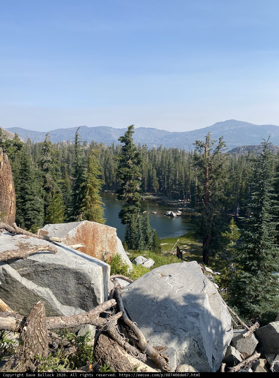 Serene Lake View from Rocky Hillside