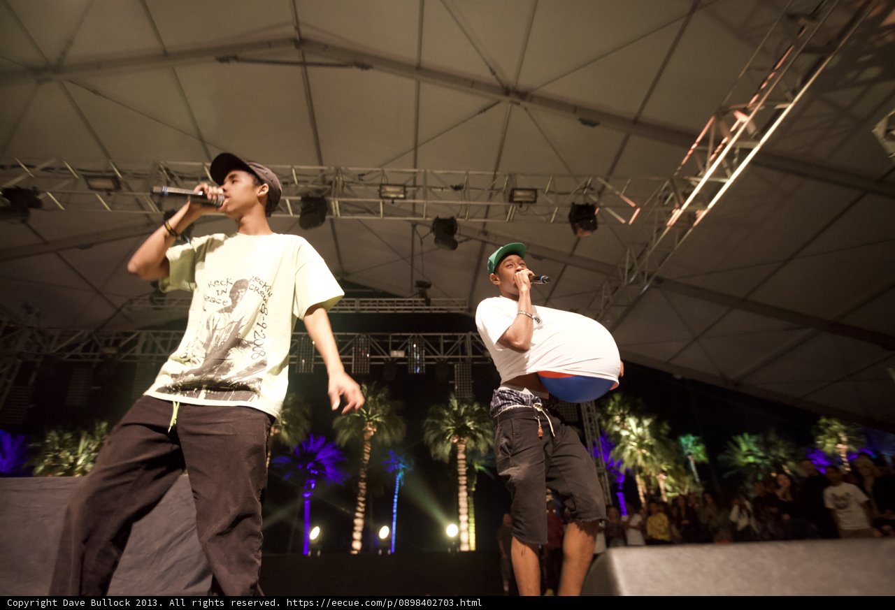 Tyler, The Creator performing on stage with a friend