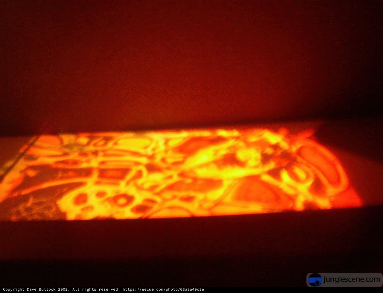 Projected Painting Illuminates Wall with Fiery Colors