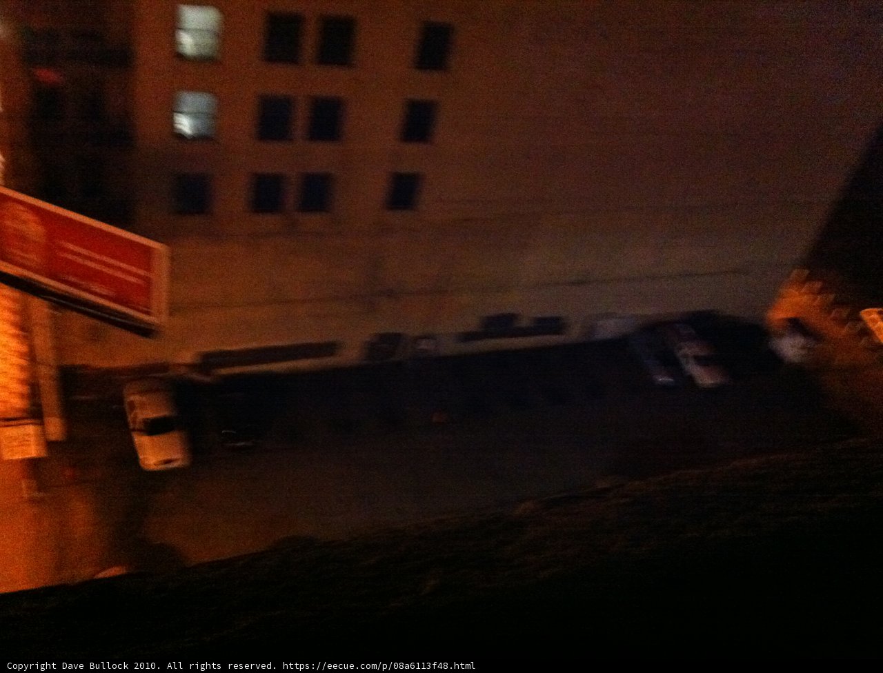 Nighttime View of Urban Parking Lot from Window