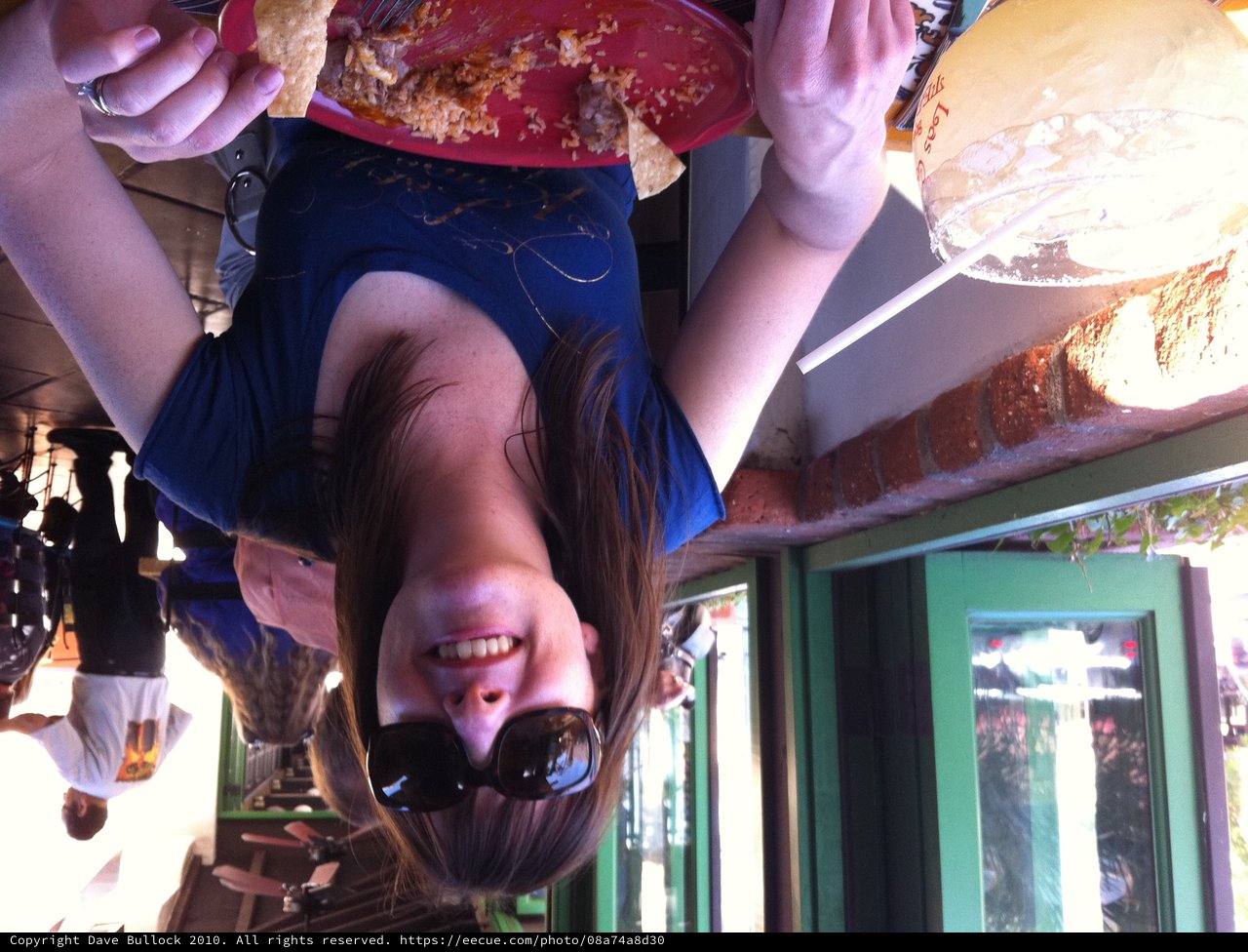 Woman Smiling Over Mexican Food at Outdoor Restaurant