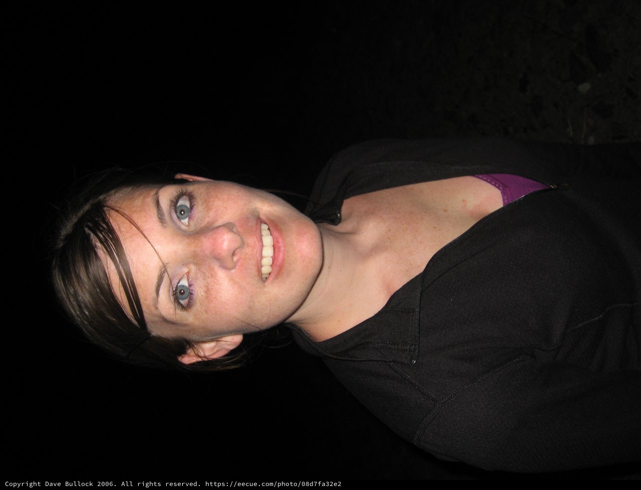 Young Woman Smiling in Dark Night Setting